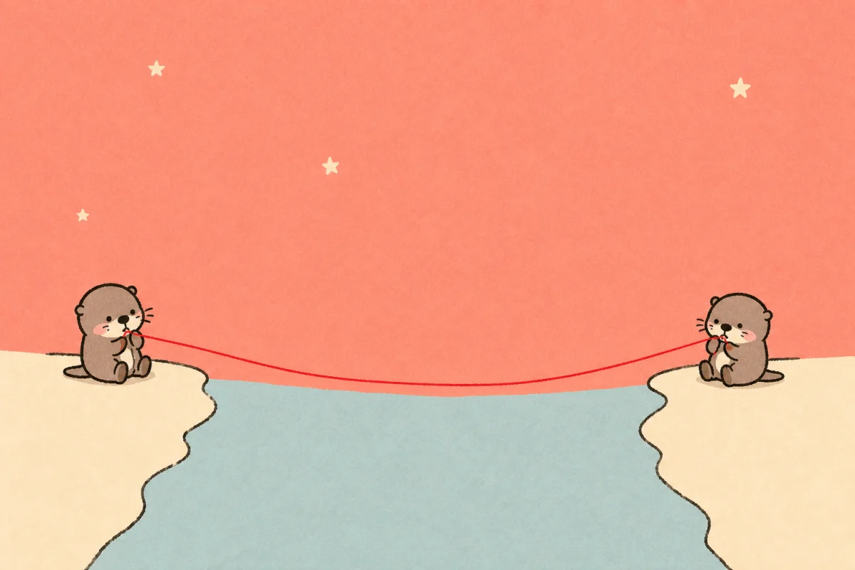 Two small Moyu otters sitting on opposite banks of a pale blue river and holding the ends of one red thread